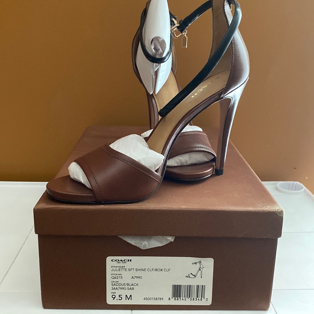 Never worn leather Coach heels in the original box.